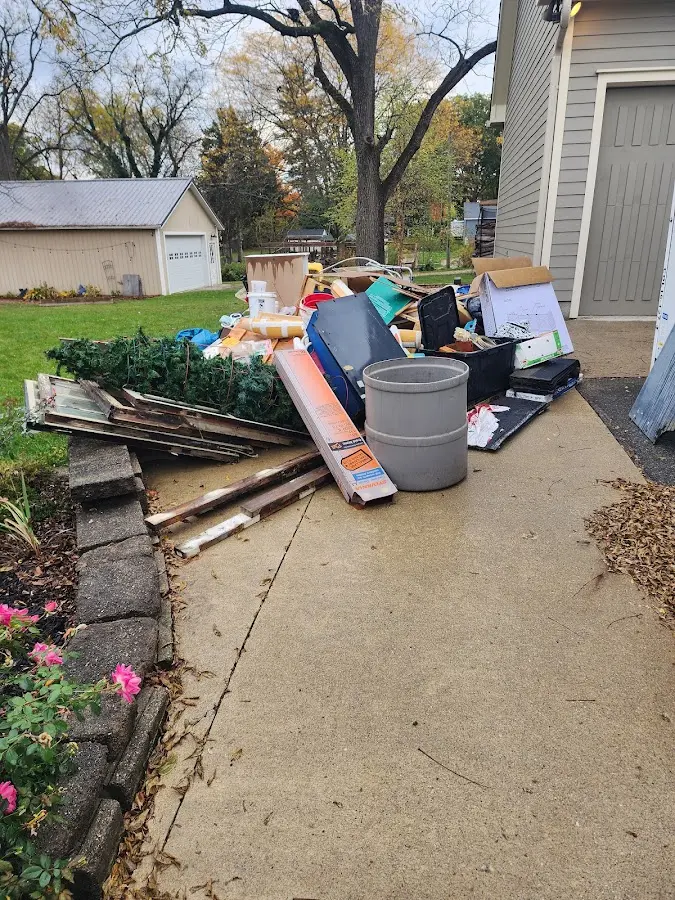 Dumpster being loaded with debris for 30 Yard Dumpster Rental in Fenton